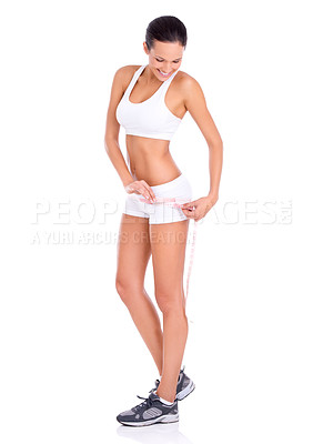 Buy stock photo Studio shot of a fit young woman taking her measurements isolated on white