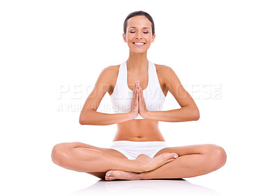 Buy stock photo Studio shot of a young woman in the lotus position isolated on white