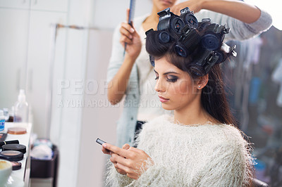 Buy stock photo Model, woman and phone with hairdresser for beauty, hair stylist and behind the scenes with social media search. Salon, beautician and person with smartphone for internet scroll while getting ready  