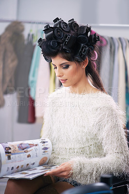 Buy stock photo Woman, hair and makeup with curlers in salon, cosmetic care and model with magazine for treatment. Beauty, shampoo and girl backstage reading with hairdresser and styling, haircare and glamour