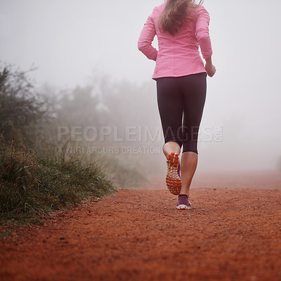 Buy stock photo Woman, rear view and running in forest with fitness for exercise, morning routine and workout with fog and legs. Athlete, person and cardio with sportswear on mountain trail and woods for wellness