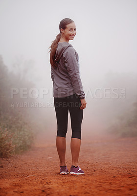 Buy stock photo Woman, portrait and hiking in forest with fog for exercise, morning routine and workout with fitness and smile. Athlete, face and person with happiness on mountain trail for wellness and healthy body