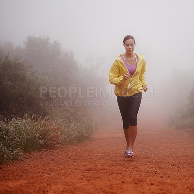 Buy stock photo Woman, health and running in forest with fitness for exercise, morning routine and workout with fog and confidence. Athlete, person and cardio with sportswear on outdoor trail and woods for wellness