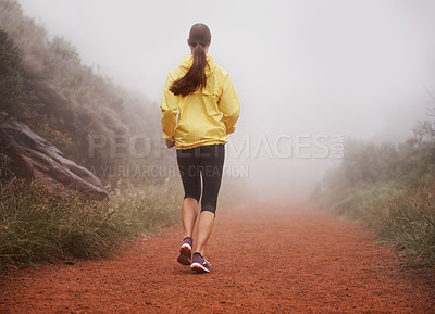 Buy stock photo Woman, rear view and running in forest with fitness for exercise, morning routine and workout with fog and legs. Athlete, person and cardio with sportswear on outdoor trail and woods for wellness