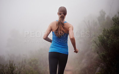 Buy stock photo Woman, rear view and running in woods with workout for exercise, morning routine and fitness with fog and mist. Athlete, person and cardio with sportswear on outdoor trail and forest for wellness
