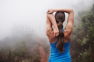 Buy stock photo Rearview shot of a young female runner training outdoors