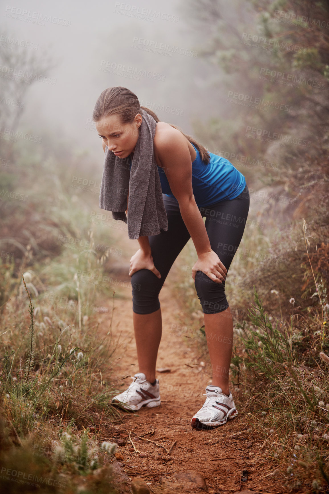 Buy stock photo A young female runner training outdoors