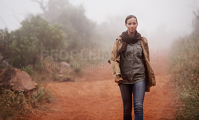 Buy stock photo An attractive young woman out for a walk in the mountains