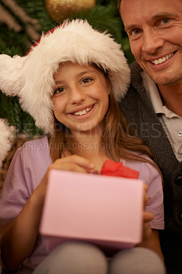 Buy stock photo Christmas, portrait and child with gift box, dad and celebration together with happy surprise. Holiday, father and daughter smile in living room for present giving, festive xmas and love in home.