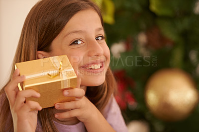 Buy stock photo Christmas, tree and portrait of child with gift, smile and celebration with happy surprise in home. Holiday, festive and girl with present giving, xmas fun and excited in living room with mockup