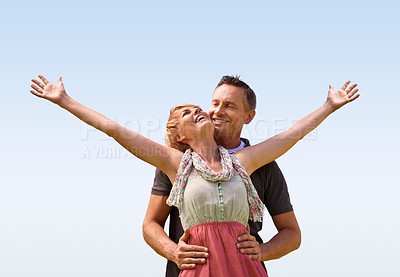 Buy stock photo Couple, hug and smile with love outdoors for honeymoon vacation, together and arms up for freedom. Man, woman and relationship with care for romance, marriage and support with trust for happiness