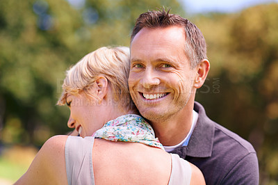 Buy stock photo Love, couple and hug in nature with support, commitment and trust, care and solidarity while bonding in a park. Safety, security and people embrace in a garden with peace, calm or soulmate connection
