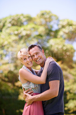 Buy stock photo Portrait, love, and happy couple hug in a park with trust, support or solidarity, security or bonding in nature. Commitment, face or people embrace in a garden for spring romance, fun or outdoor date