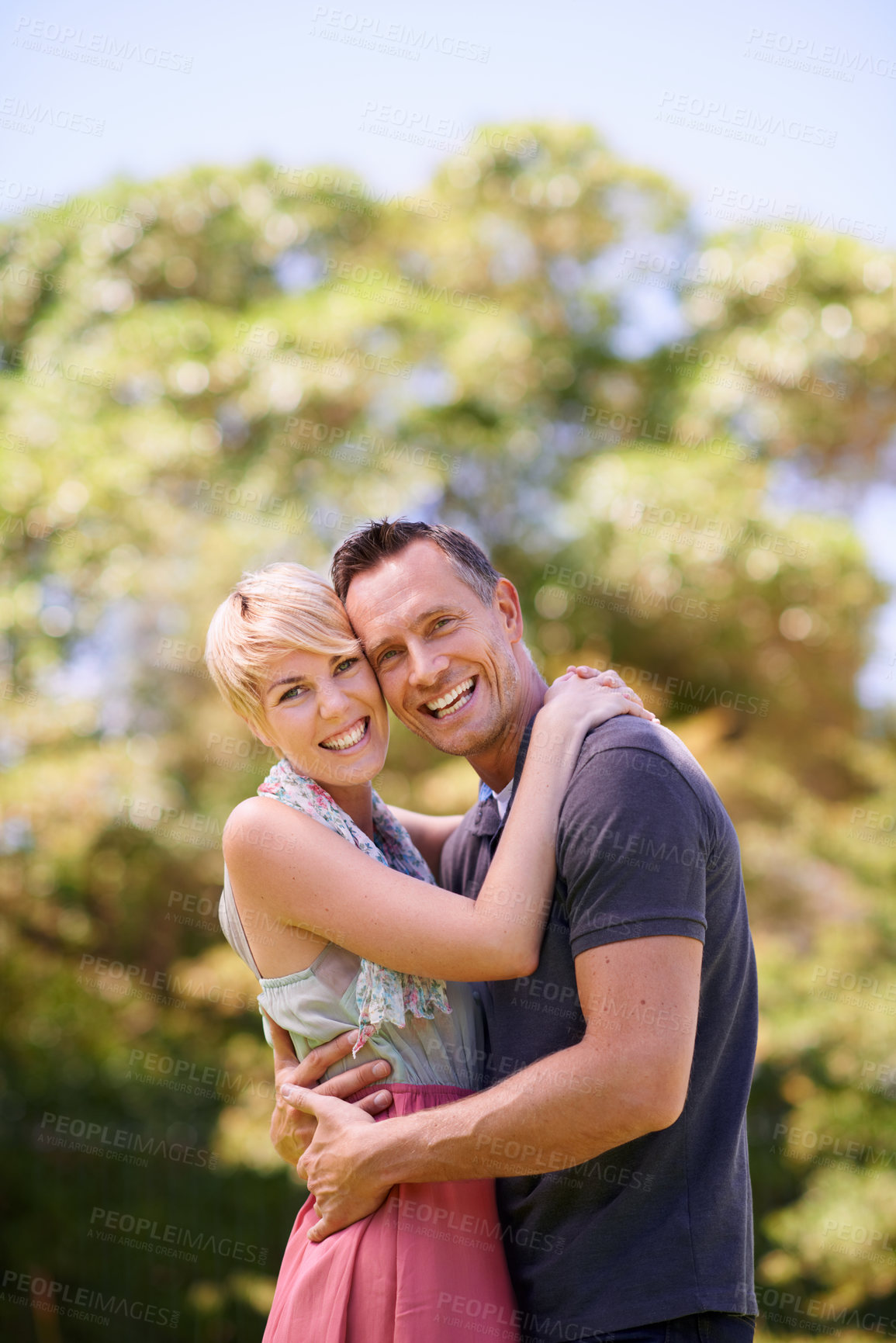 Buy stock photo Portrait, love, and happy couple hug in a park with trust, support or solidarity, security or bonding in nature. Commitment, face or people embrace in a garden for spring romance, fun or outdoor date