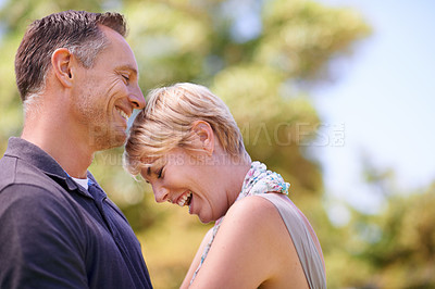 Buy stock photo Shot of a mature couple sharing a tender moment outdoors