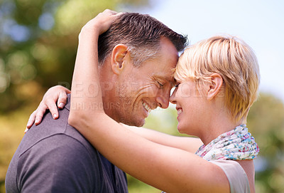 Buy stock photo Love, hug and couple in nature with romance, support and trust, bonding and sharing sweet moment outdoor together. Safety, smile or happy people embrace in a forest for summer date, solidarity or fun