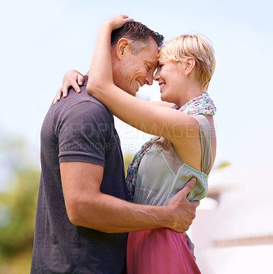 Buy stock photo Shot of a mature couple embracing outdoors