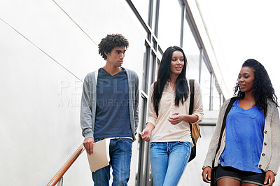 Buy stock photo University, friends and group of students walking on stairs talking, speaking and in conversation on campus. Education, college and women and men chat for academy, learning and studying together