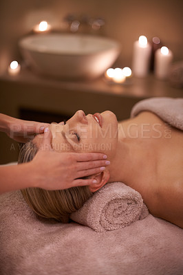 Buy stock photo Face massage, spa and relax with woman, luxury and candle with hospitality and stress relief. Person, facial and girl with wellness or healthy with vacation or beauty with holiday, detox or self care