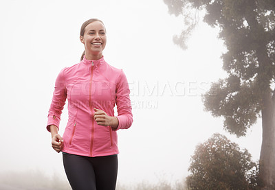 Buy stock photo Nature, fitness and young woman athlete running on mountain road for race, marathon or competition training. Sports, exercise and female person with cardio workout in misty outdoor woods or forest.