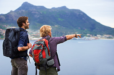 Buy stock photo Friends, hiking and travel on mountains with adventure, explore and view of island, nature and location in Europe. People with backpack and pointing for trekking, journey and destination by the ocean