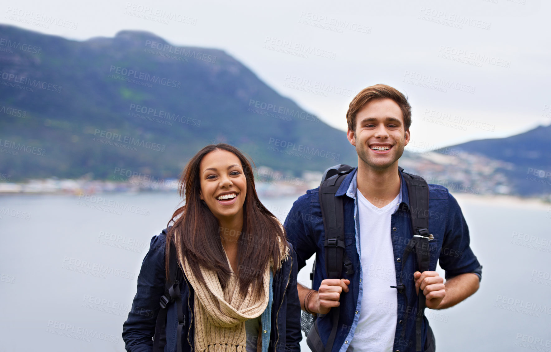 Buy stock photo A happy young couple with backpacks enjoying nature