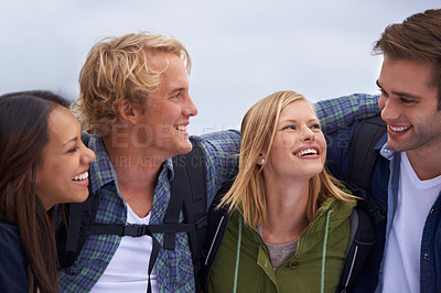 Buy stock photo Friends, group and happy for hiking, adventure and travel together in conversation, hug and love outdoor. Excited and young people with backpack and laughing for funny discussion, trekking or journey