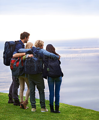 Buy stock photo Friends, people hug with back and hiking on mountain, travel with view of horizon outdoor, ocean and backpacking in Europe. Support, trust and friendship, trekking for adventure and looking at nature