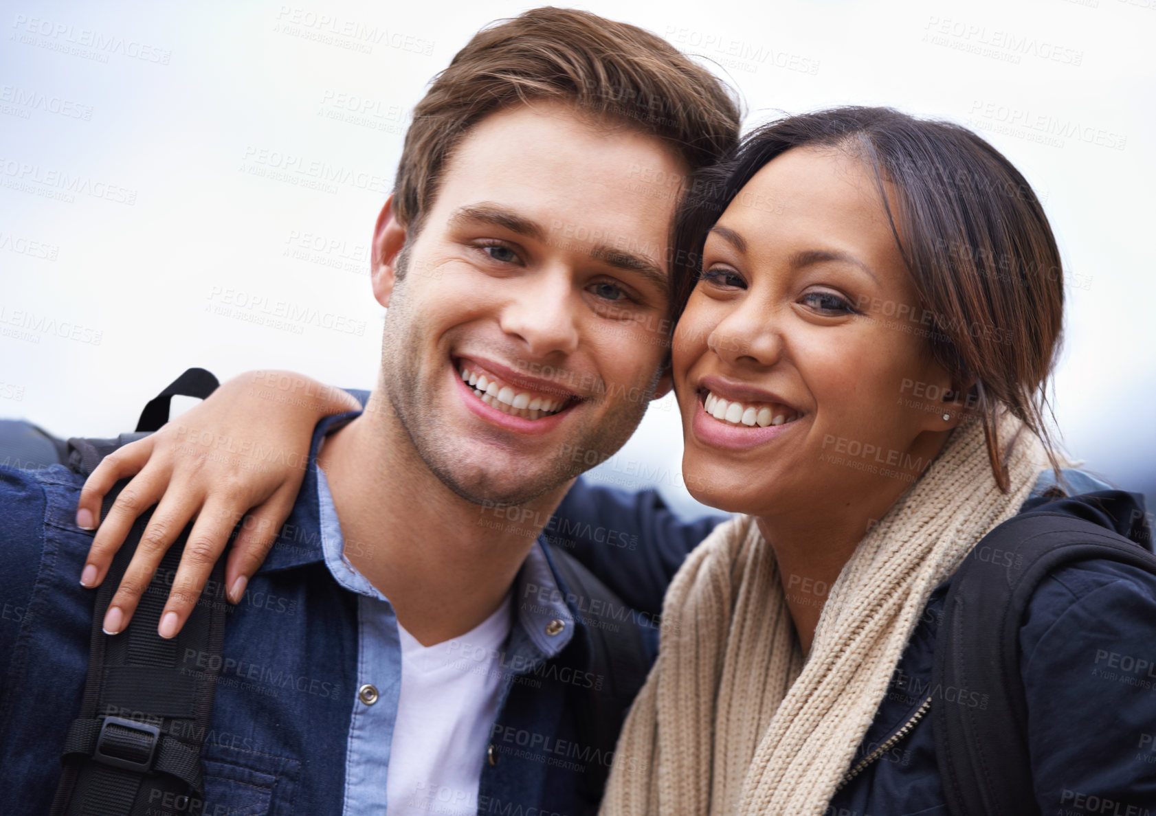 Buy stock photo Couple, portrait and outdoor for hiking, adventure and travel in winter, grey or cloudy sky in smile and backpack. Face, happy or interracial people with hug in profile picture or selfie for trekking