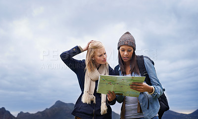 Buy stock photo Woman, friends and thinking with map for direction or location on hiking adventure together in nature. Young female person, hiker or team lost with travel guide for destination, route or outdoor path