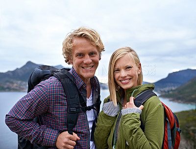 Buy stock photo Happy couple, portrait and hiking with backpack on mountain for sightseeing, travel or outdoor journey in nature. Face of young man, woman or hikers carrying bag for trekking, fitness or adventure