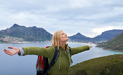 Buy stock photo Woman, hiking and freedom on mountains for travel, success and achievement or fresh air in Europe. Young person with backpack, breathing and stretching arms for trekking, journey or outdoor adventure