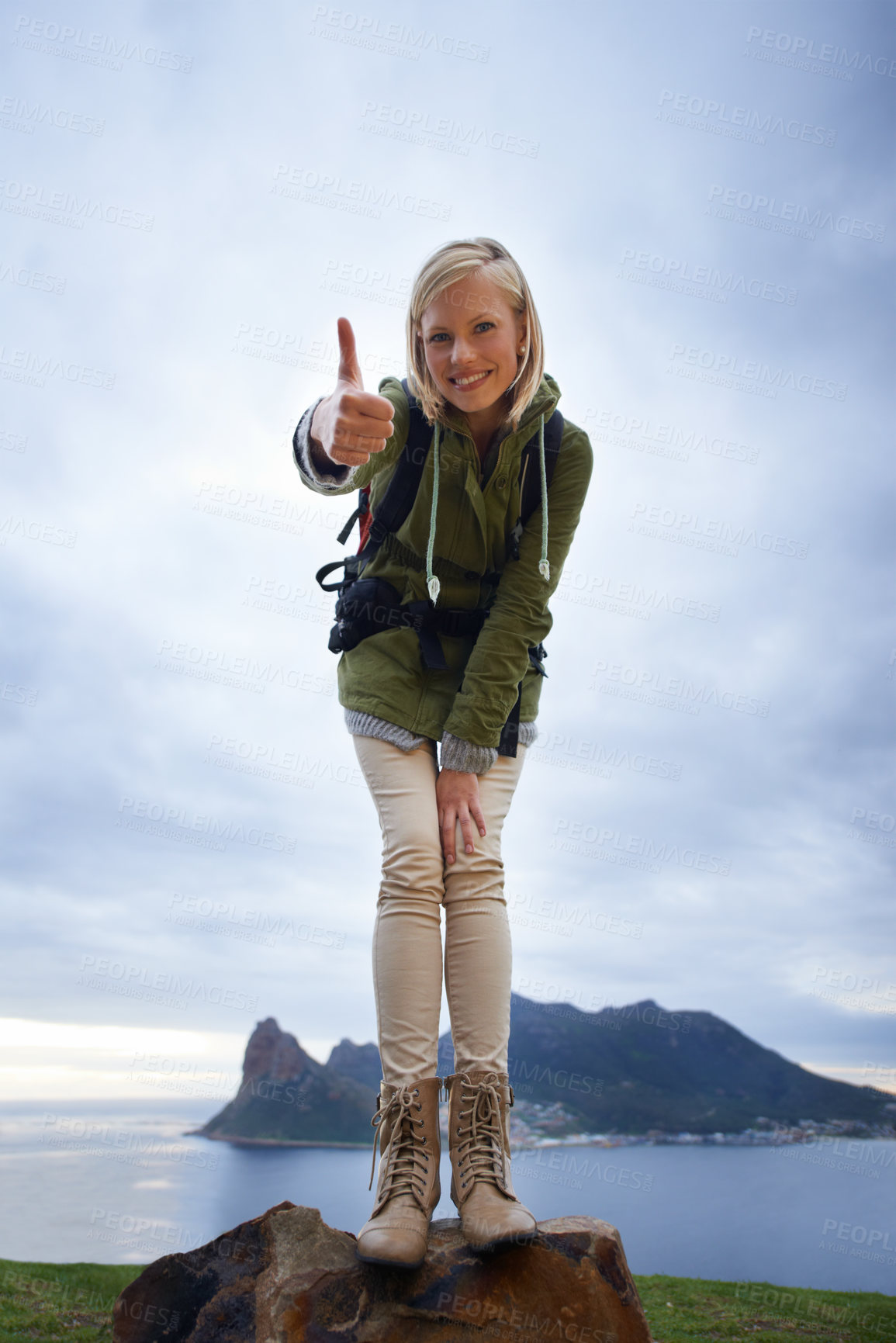 Buy stock photo Woman, hiking and thumbs up on mountain for fitness, outdoor and travel with success, vote and goals in Europe. Portrait of person in backpack and like or yes hand for trekking or adventure by island