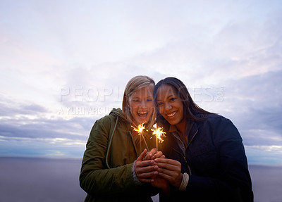Buy stock photo Women, friends and portrait with sparklers outdoor, celebration and fun with hiking or travel in nature. Friendship, bonding and sparks with horizon, happy for adventure together and evening sky