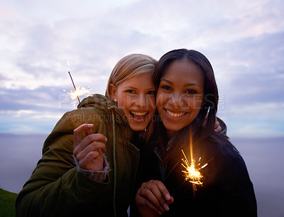 Buy stock photo Women, friends and portrait with sparklers in nature celebration and fun with smile or travel outdoor. Friendship, bonding and sparks with horizon, happy for adventure together and evening sky