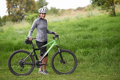 Buy stock photo Portrait, smile for cycling and woman in countryside with bike for off road training, cardio or hobby. Exercise, fitness or sports and happy young athlete or cyclist in nature with helmet for workout