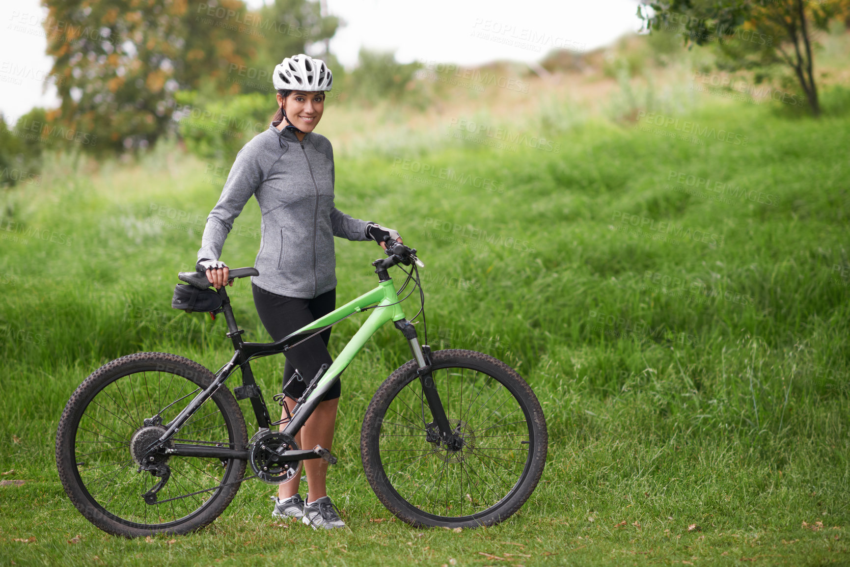 Buy stock photo Portrait, smile for cycling and woman in countryside with bike for off road training, cardio or hobby. Exercise, fitness or sports and happy young athlete or cyclist in nature with helmet for workout