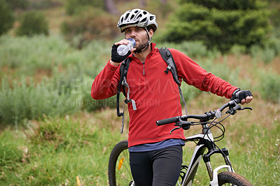 Buy stock photo Fitness, bike and man drinking water in countryside for adventure, discovery or off road sports hobby. Exercise, health and wellness with young cyclist on break in nature for training or cycling