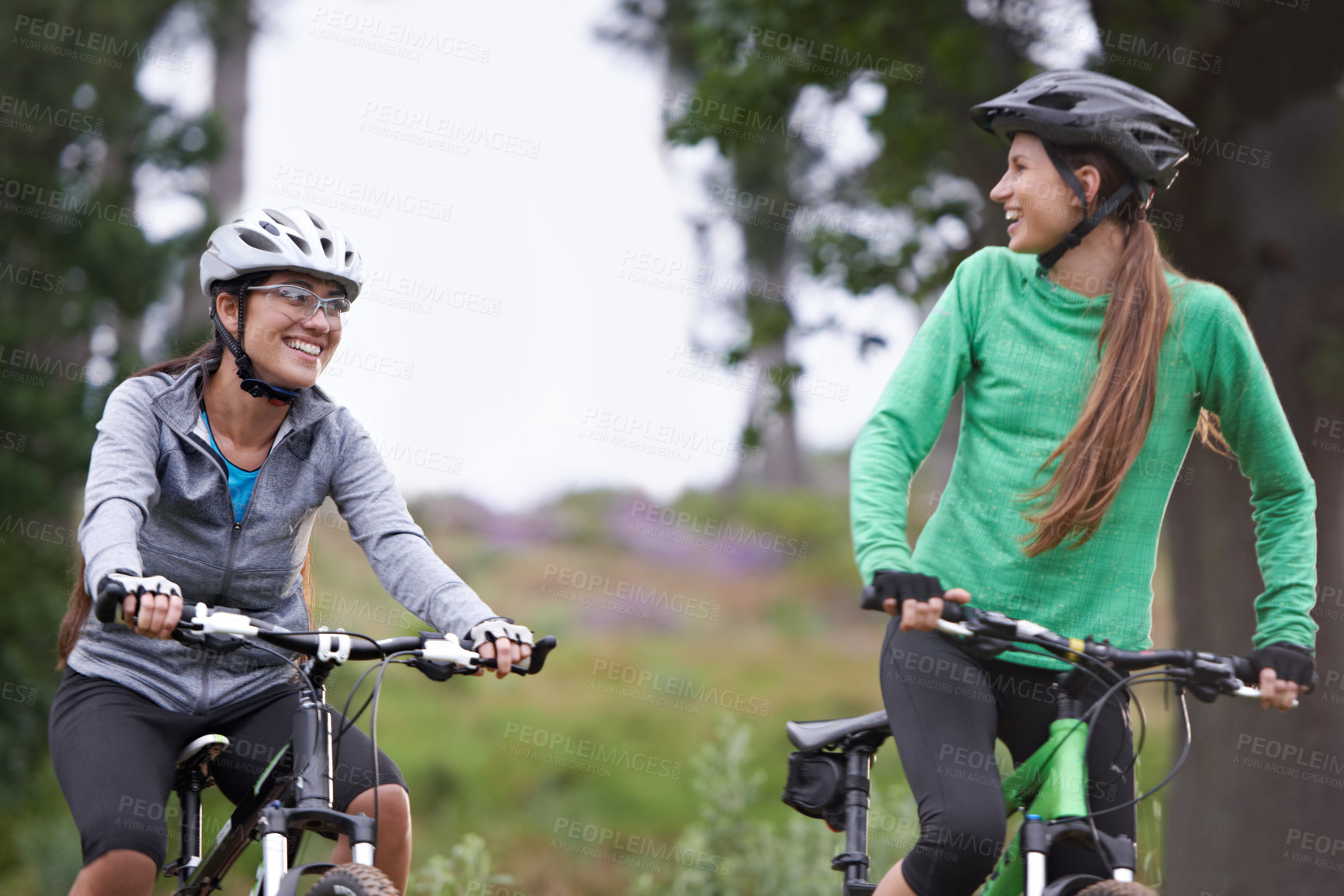 Buy stock photo Happy woman, friends and forest with bicycle on field for outdoor cycling, workout or cardio exercise in nature. Female person, athlete or cyclist with smile in fitness for off road training on trail