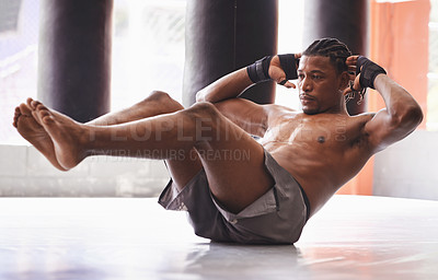 Buy stock photo Shot of a middle-age boxer working out his abs in a gym