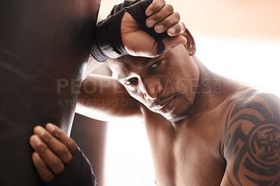 Buy stock photo Punching bag, portrait and tired black man in gym for boxing challenge, fight and competition training. Power, muscle and exhausted face of champion boxer at workout with fatigue in sports club.
