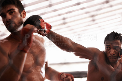 Buy stock photo Shot of a two young man sparring in a ring