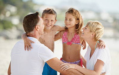 Buy stock photo Parents, kids and happiness for bonding at beach on summer, holiday and hug in Florida. Family, children and circle in hot weather with smile, laugh and travel for vacation with trip and break. 