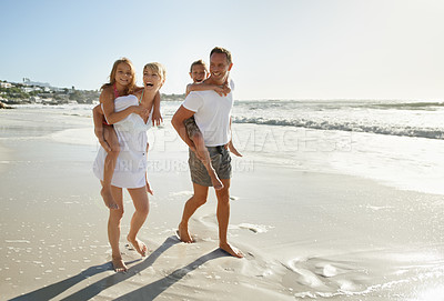 Buy stock photo Family, beach and fun of mother, father and kids together with a piggy back outdoor in nature. Sea, smile and happiness with bonding, parent support and love while laughing by the ocean on holiday