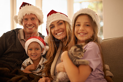 Buy stock photo Christmas, happy and cat with family on sofa for celebration, festive and gift giving for holiday season. Relax, smile and present with portrait of parents and kids with pet kitten for xmas bonding