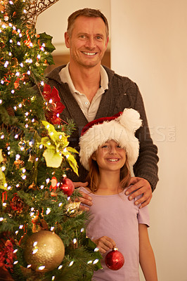 Buy stock photo Father, girl and Christmas tree, celebration and happy smile, hat and festive holiday, portrait and love in family home. Mature man, child and decoration, happiness and excited on xmas event in house