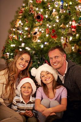 Buy stock photo Portrait, happy family and christmas tree in living room, smile and celebrate for love or happiness. Mother, father and young children or smiling at home for christmas festive celebration together.