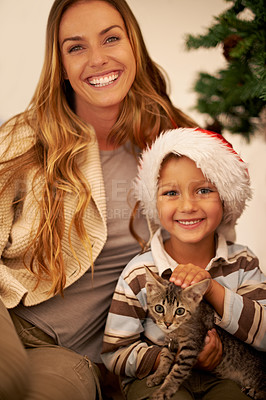 Buy stock photo Portrait of family on Christmas, child with cat and mother on festive holiday together in Dallas home. Happy mom giving kitten as gift to kid, celebration of love with pet or relax by christmas tree