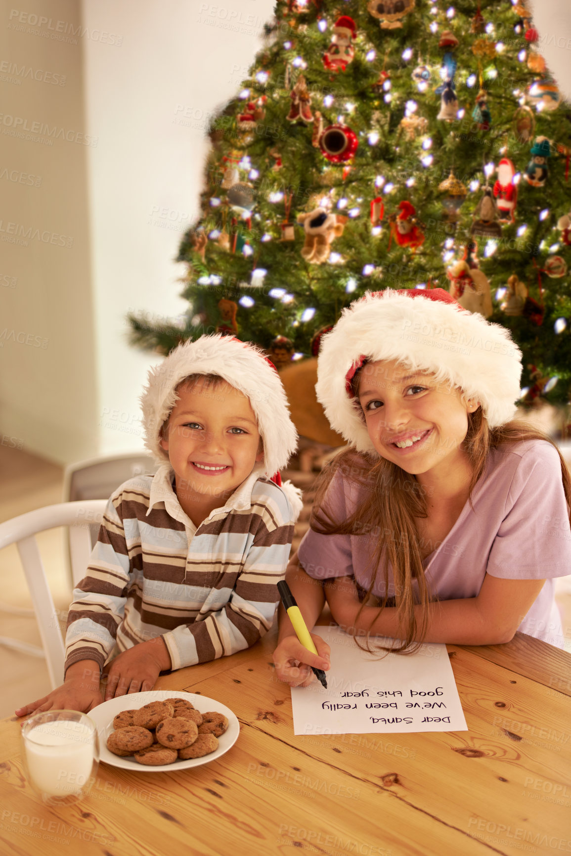 Buy stock photo Kids, portrait and christmas cookies note for festive celebration with young siblings in home. Happy, children and writing letter for santa with excited smile, milk and baked cookie recipe.

