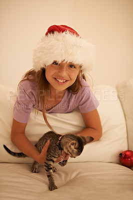 Buy stock photo Girl, Christmas celebration and kitten gift in bedroom to celebrate festive holiday. Happy child, pet cat as party present and animal care or kids happiness in bed, celebrating xmas vacation season